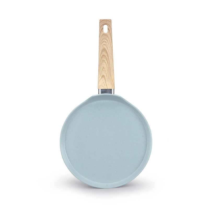 Ceramics y sartenes con utensilios de cocina forjados